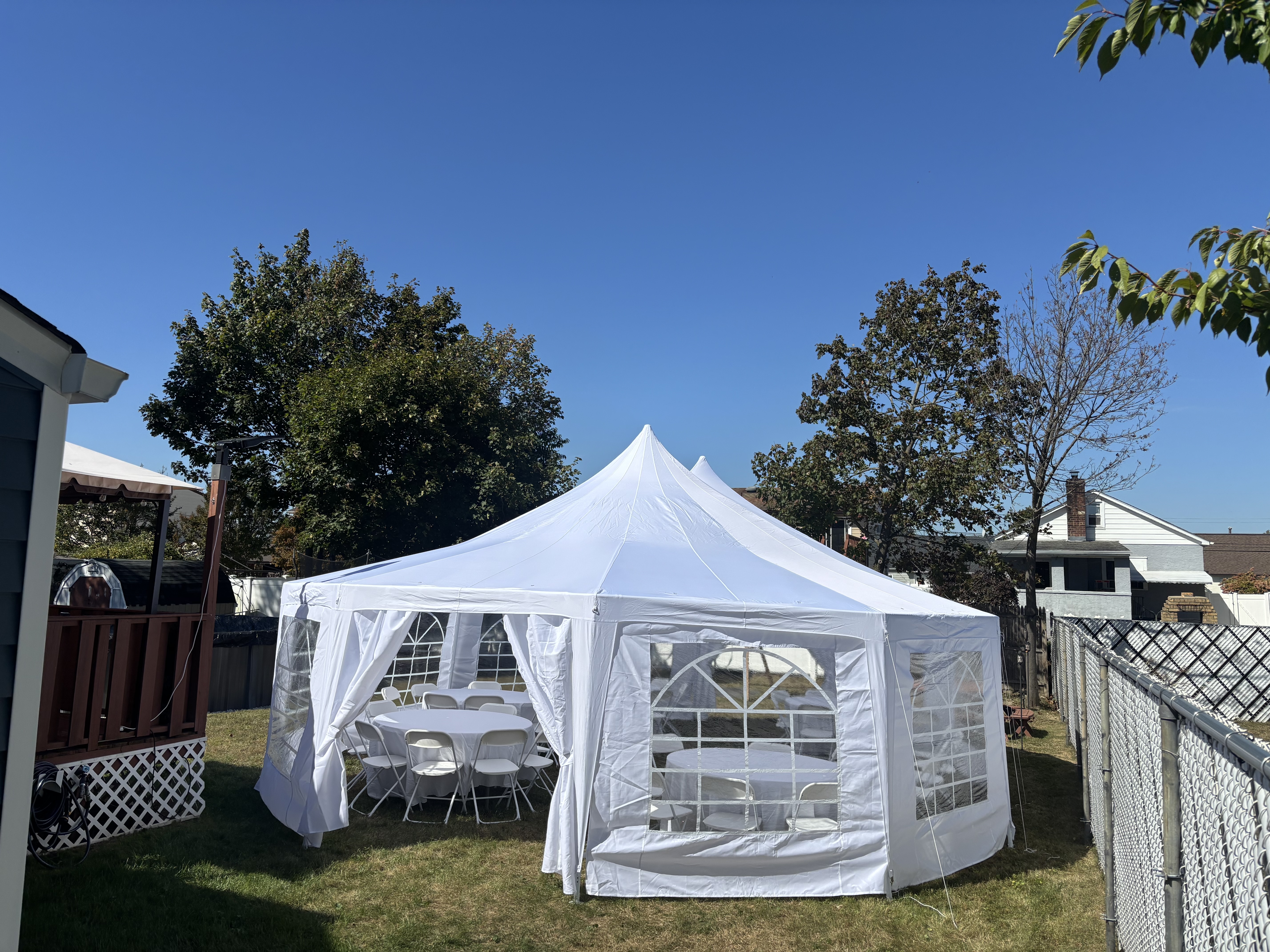 29x23 marquee tent set up in a backyard on a sunny day