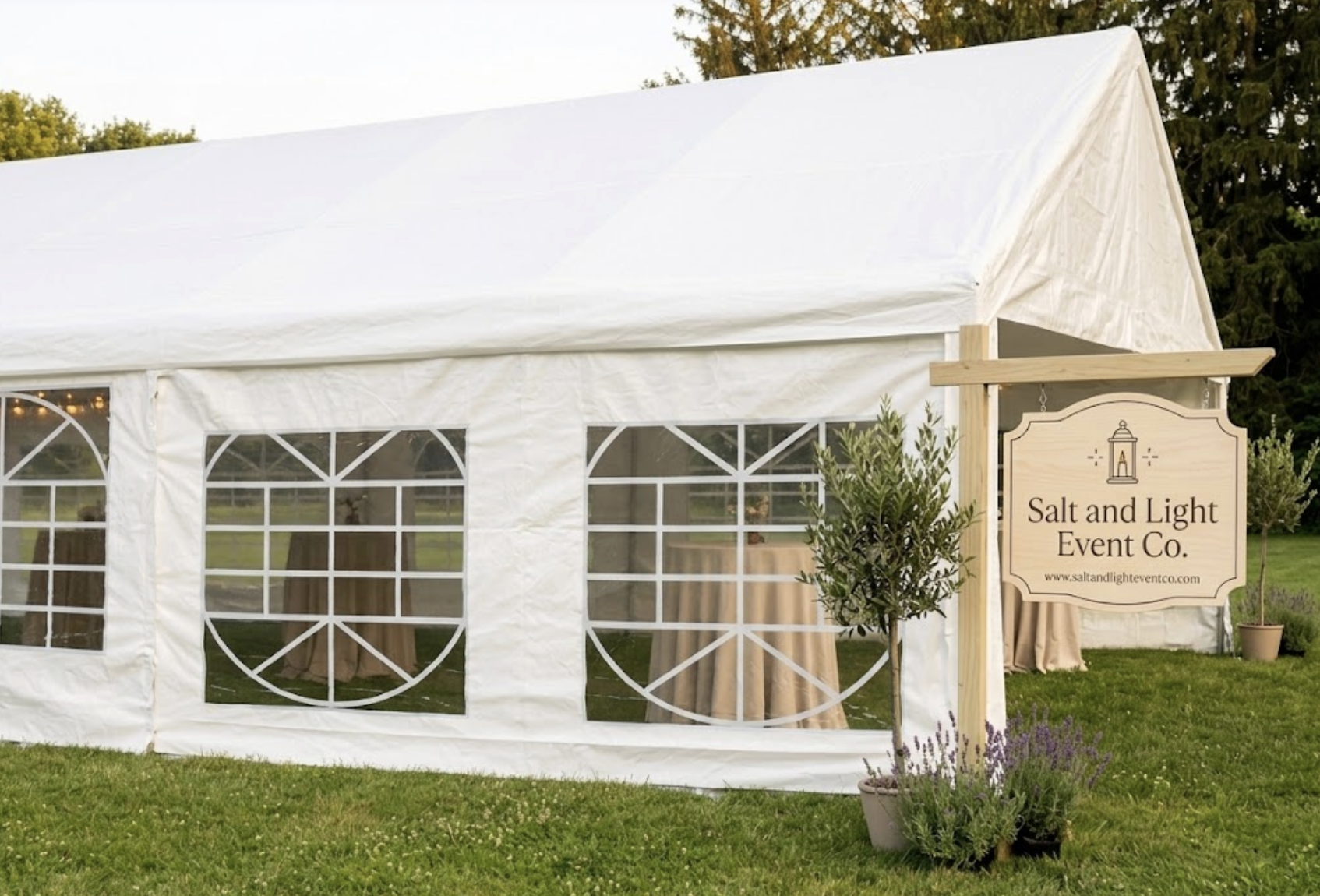 Salt and Light Event Co. — marquee tent with branded sign on a green lawn